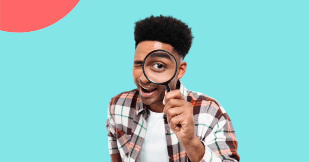 guy looking through a magnifying glass.