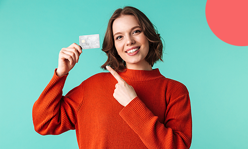 girl pointing at a credit card.