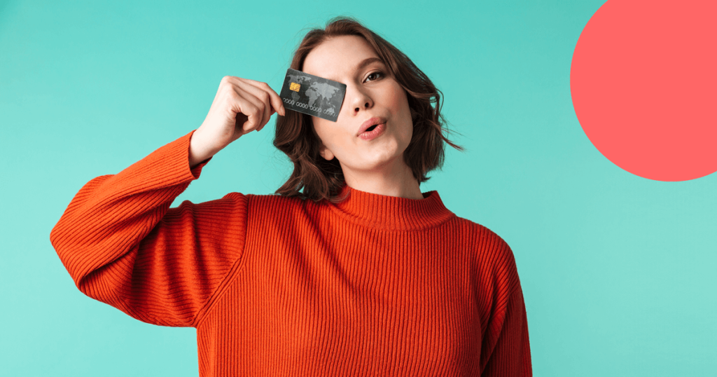 girl holding a credit card which covers her eye.